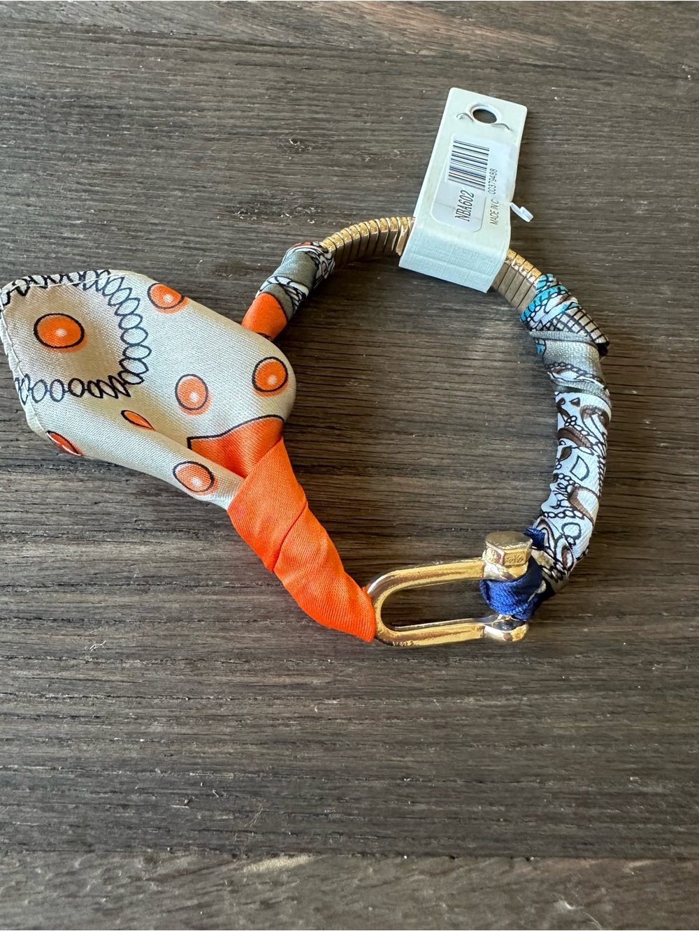 Scarf Wrapped Gold-Tone Bracelet with Orange Accent